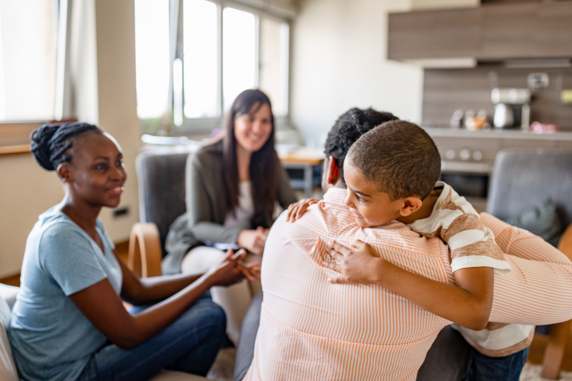 Family in session with Father hugging child.