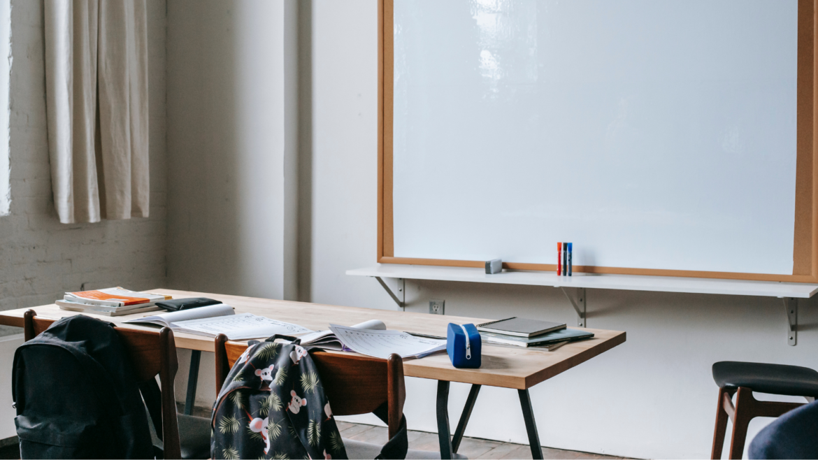 Classroom desk with backpacks