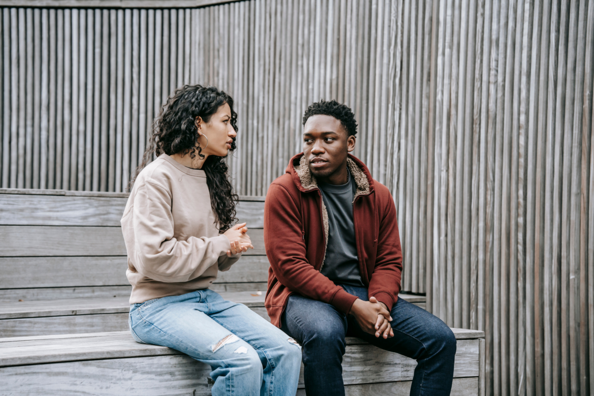 two adults having a conversation.