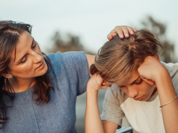 Young boy with adult talking