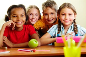 School aged kids at school desk.