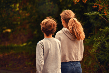 boy and girl with backs towards camera.